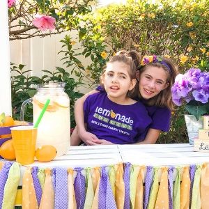 Hailey and Livy Scheinman hold a Lemonade for Livy lemonade stand.